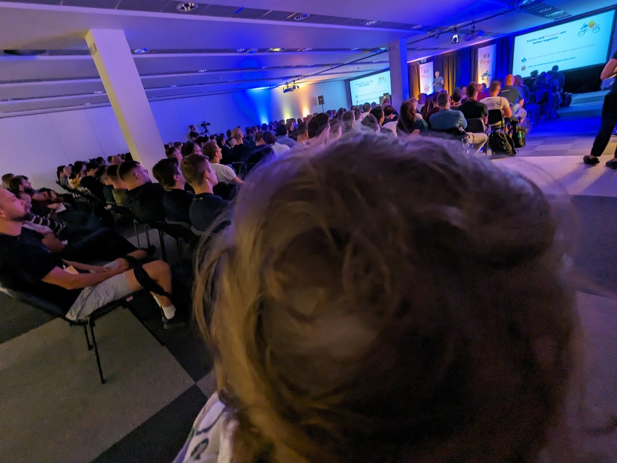 A baby behind an audience watching the keynote