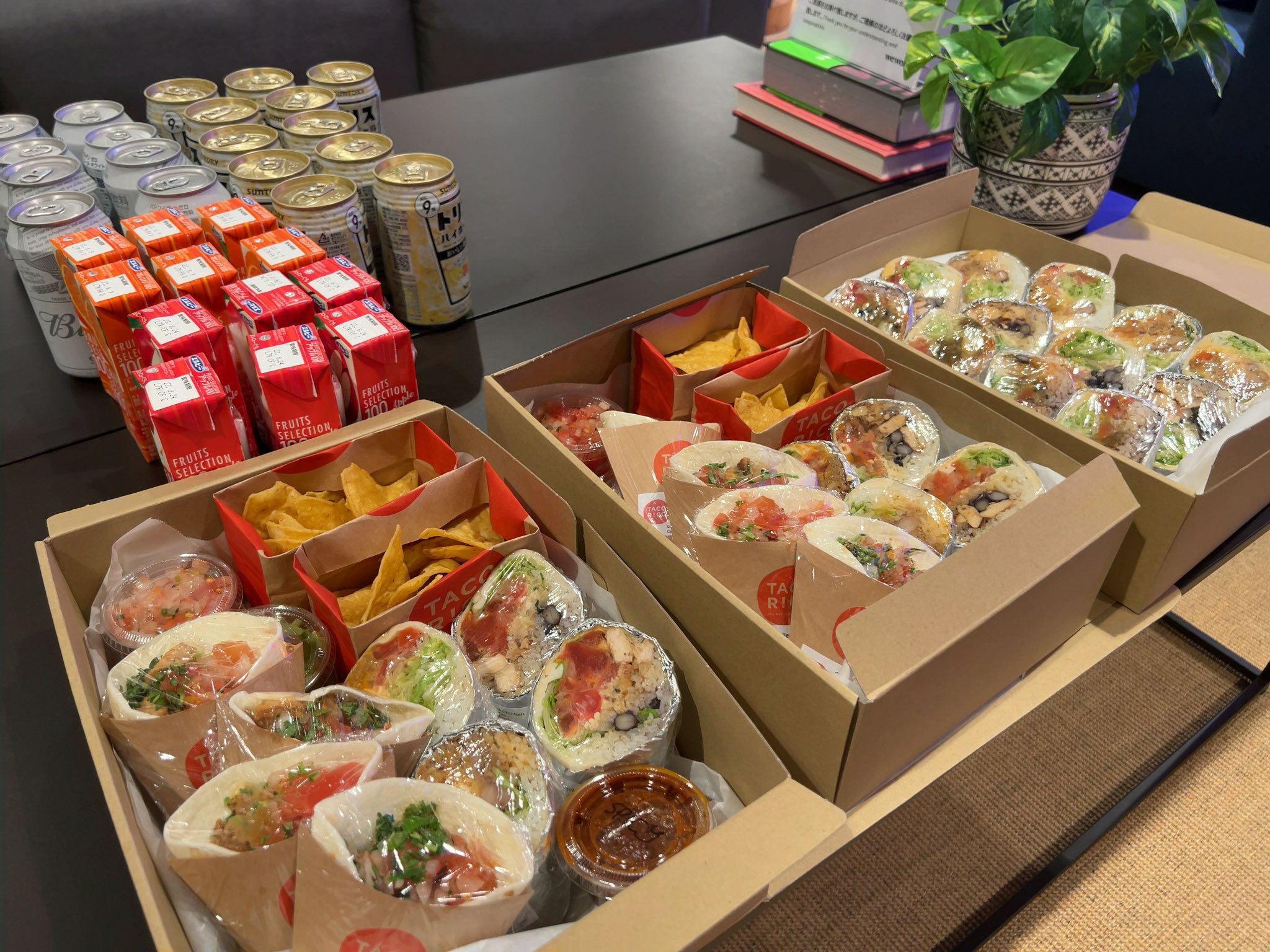 Boxes of tacos and chips and different can drinks