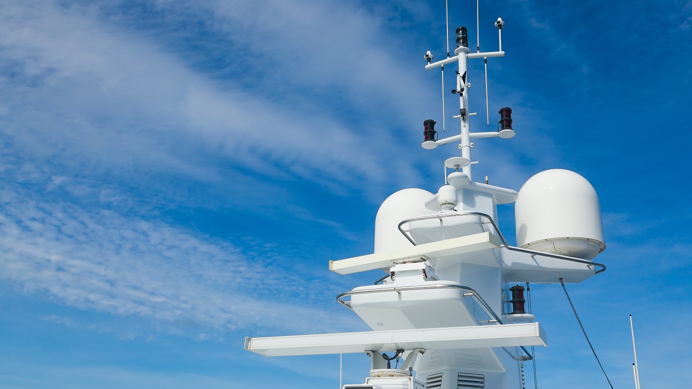 White satellite communication antennas enabling reliable communication services at sea.