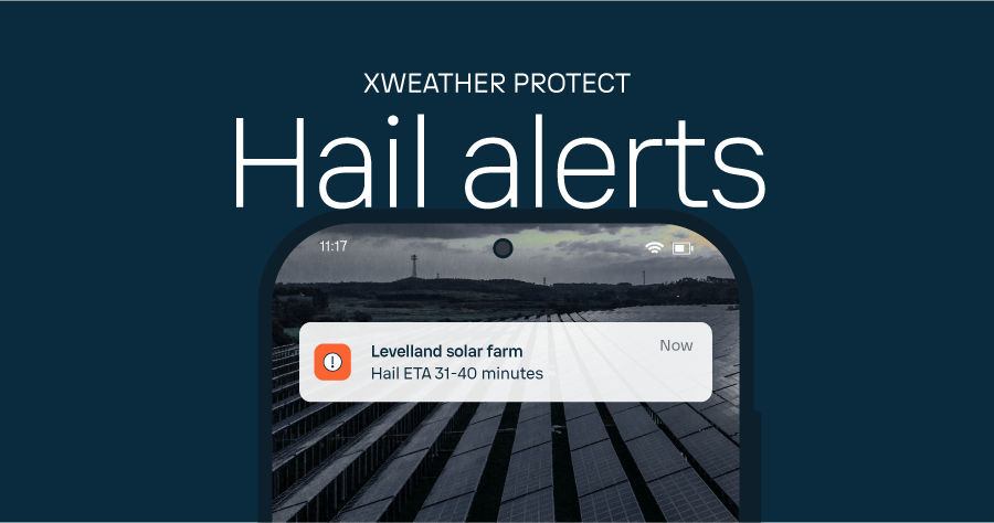 A phone screen displays an alert warning that hail will reach a solar farm