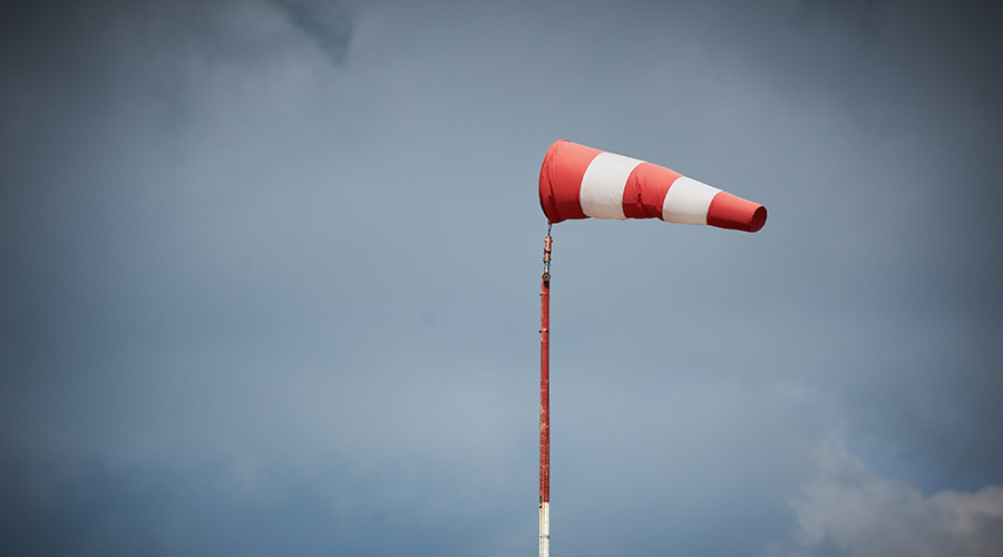 Wind sock in high winds with storm clouds behind