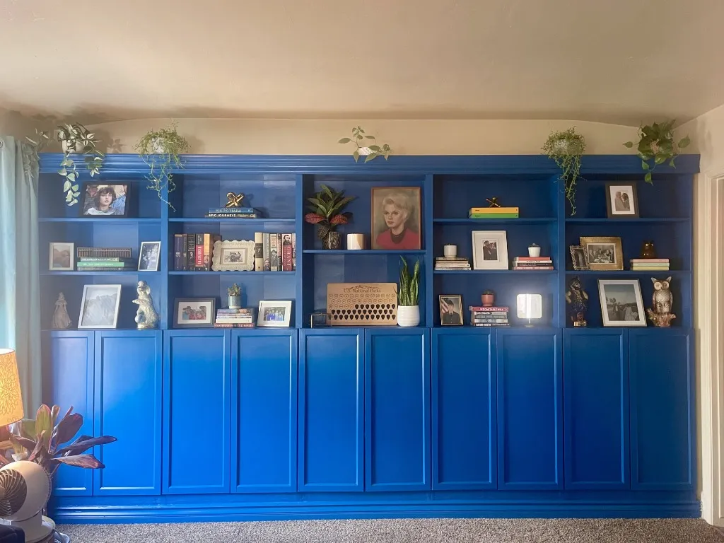 Custom blue built-in bookshelf with cabinet doors and crown molding — Long Beach handyman project