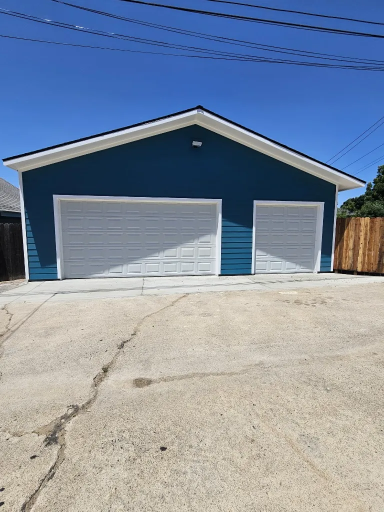Garage exterior after painting — teal blue with white doors, Long Beach CA
