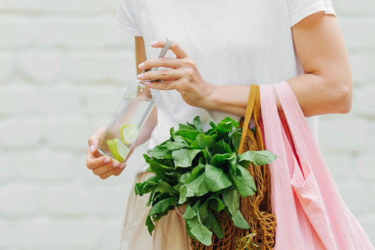 woman holding bottle and bag