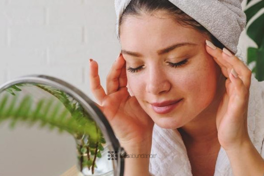 woman cleansing face