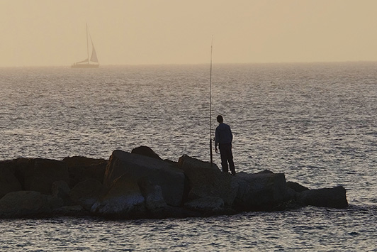 fisherman on rocks