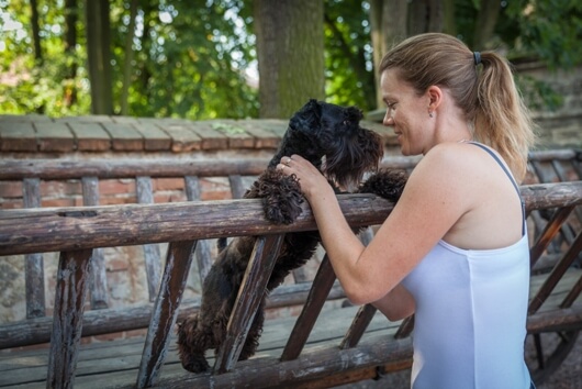 Woman And Dog Stay Cool In Summer Heat