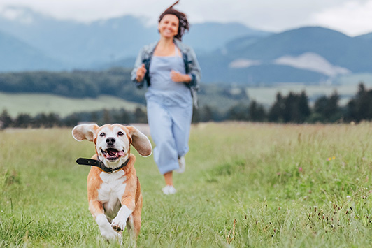 woman running with beagle