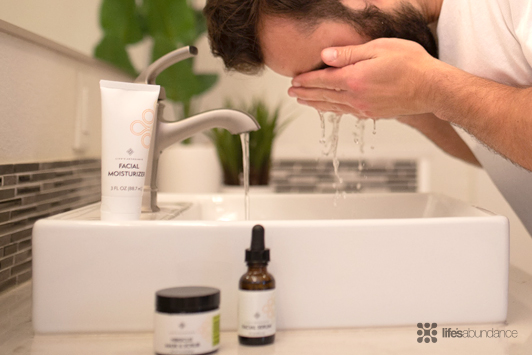 man washing his face