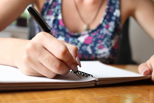 woman writing affirmations
