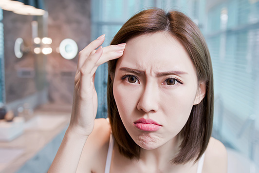Woman Frustrated That Dry Skin Is Causing Breakouts