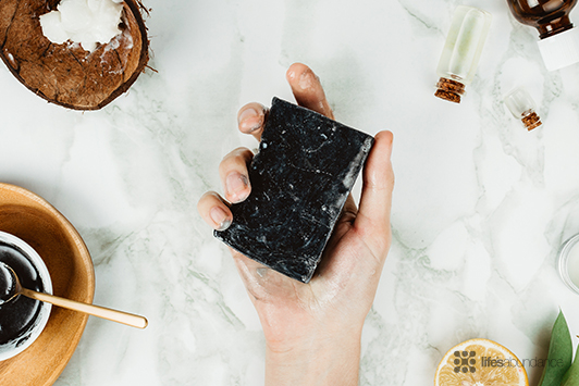 person holding charcoal soap