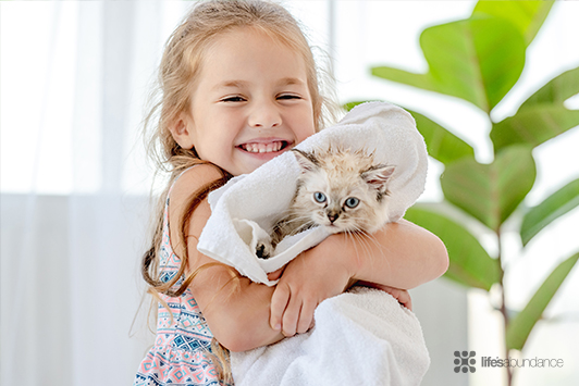 girl drying a cat