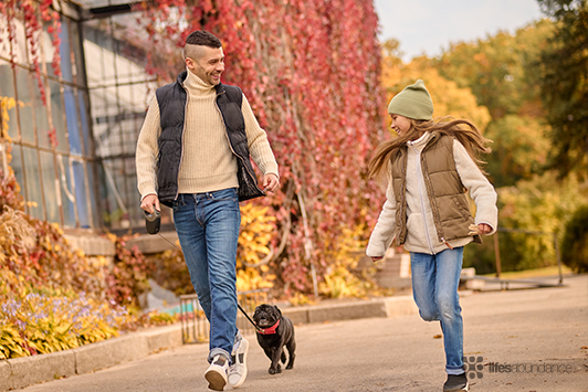 family running with their dog