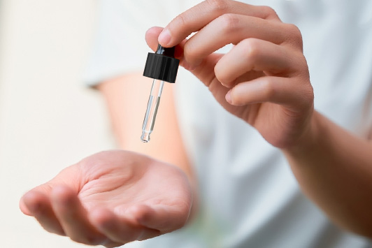serum dropper on hand
