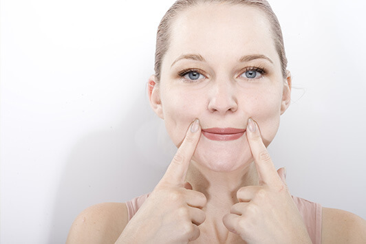 Woman Stretching Her Lips With Face Yoga