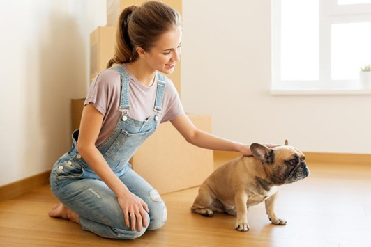 woman petting dog in new house