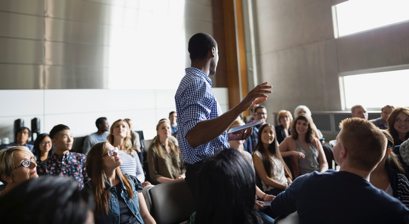 man in audience talking to group man in audience talking to group