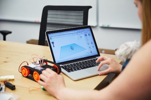 Woman working with AI device and laptop Woman working with AI device and laptop