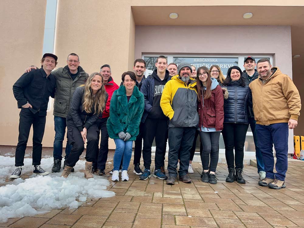 FBC team with the Mikulic family in front of the church building