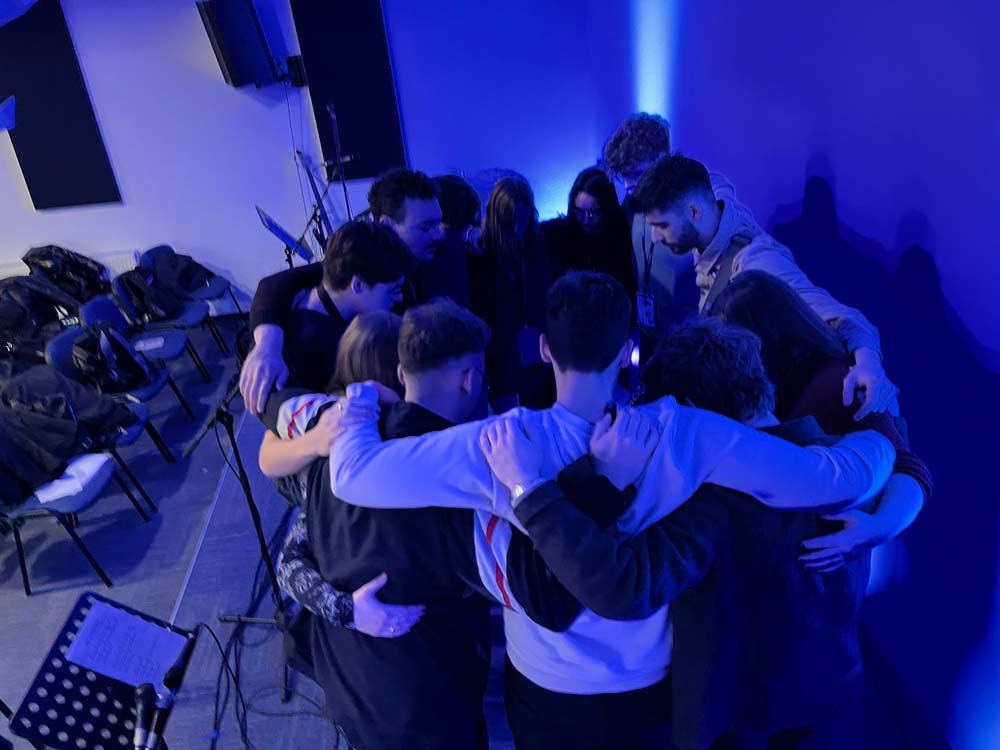 International worship team praying for the conference
