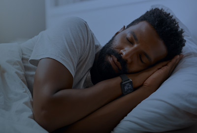 Man sleeping at home wearing CPIW activity monitor