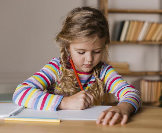 Girl writing on paper