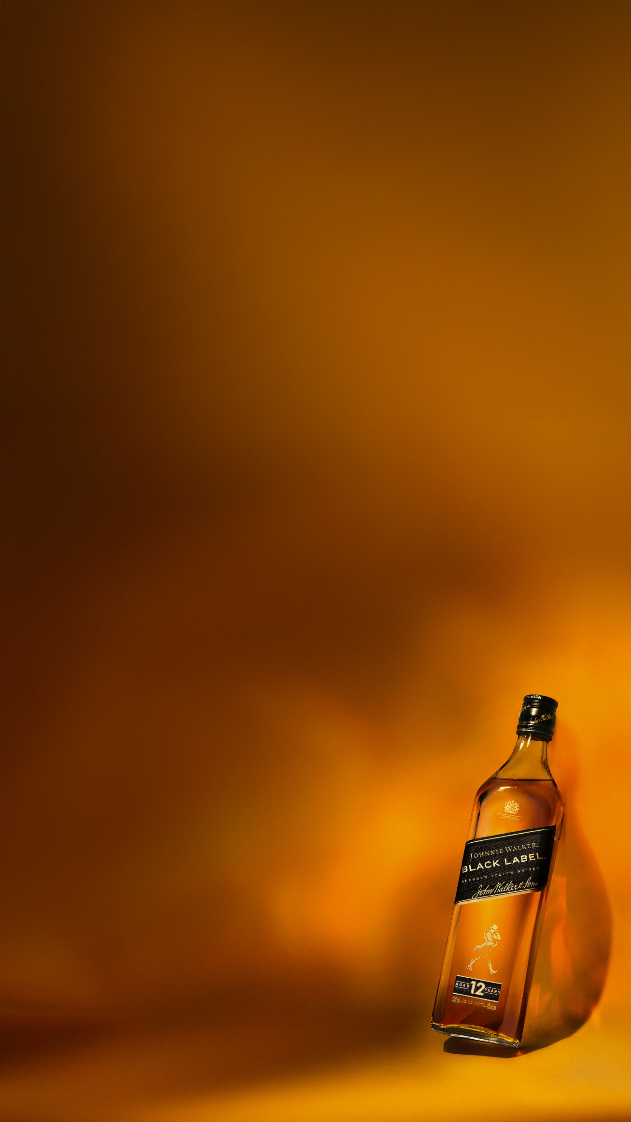 Johnnie Walker Black Label bottle on gold background.