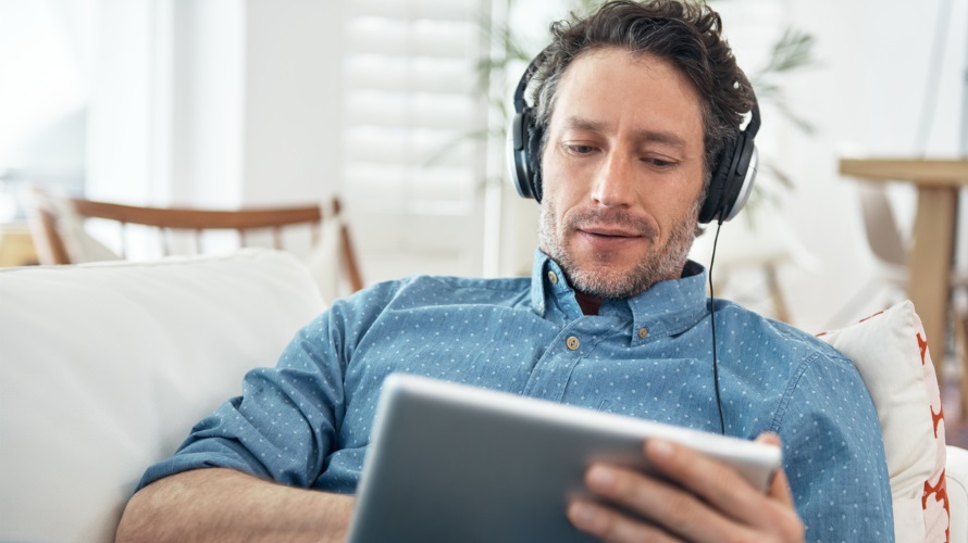ManWatchingMusicVideoOnTablet