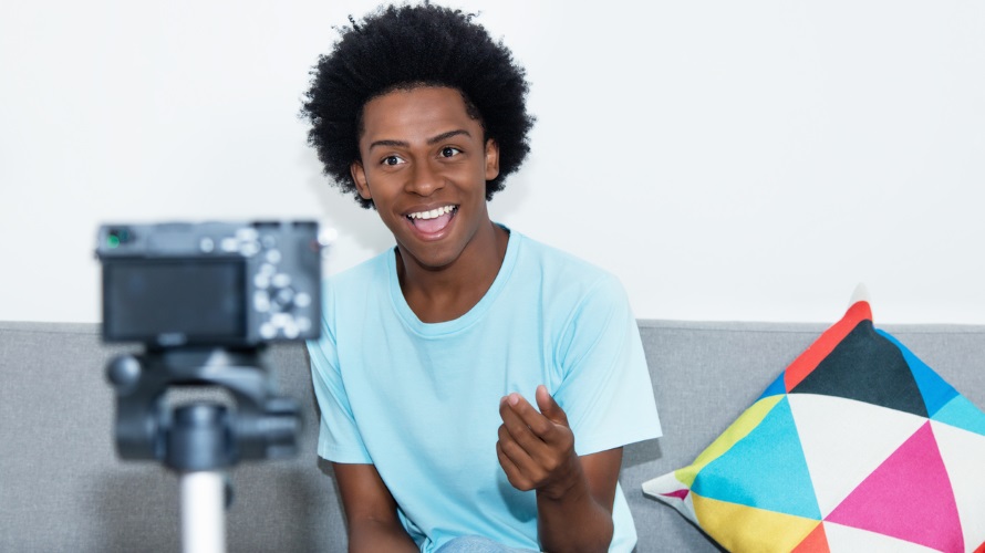 African american vlogger recording video blog at home