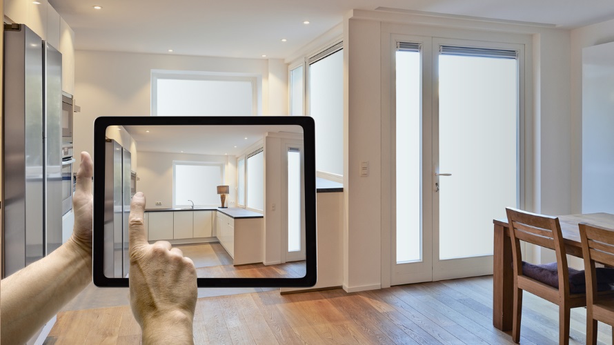 Mobile device with man hands taking picture in modern kitchen renovated