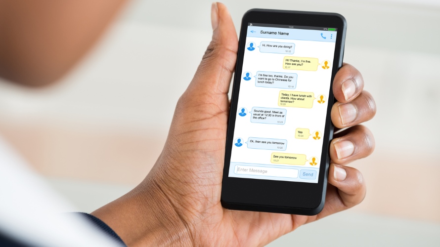 Close-up Of A Woman’s Hand Reading News On Mobile Phone