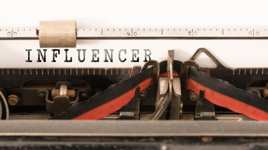 word INFLUENCER written on vintage manual typewriter