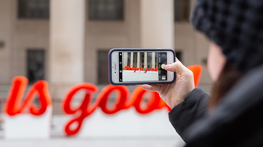 A person takes a photo of A&W Canada's straw sculpture.