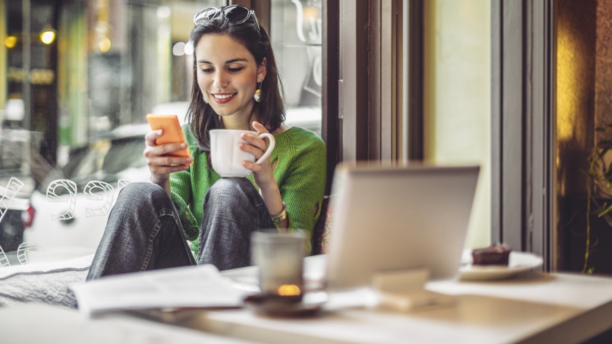 WomanSmilingSmartphoneLaptopCoffee