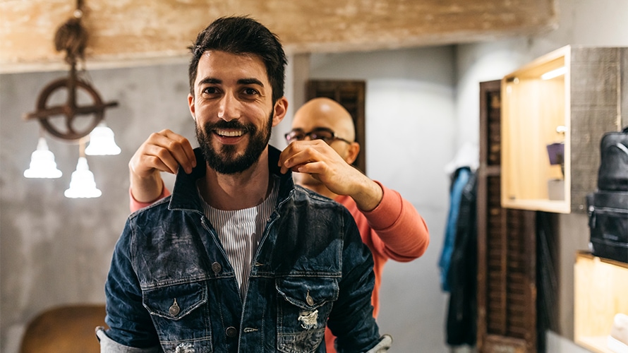 customer-focus-content-2019 a man is smiling; behind him stands another man fixing his collar