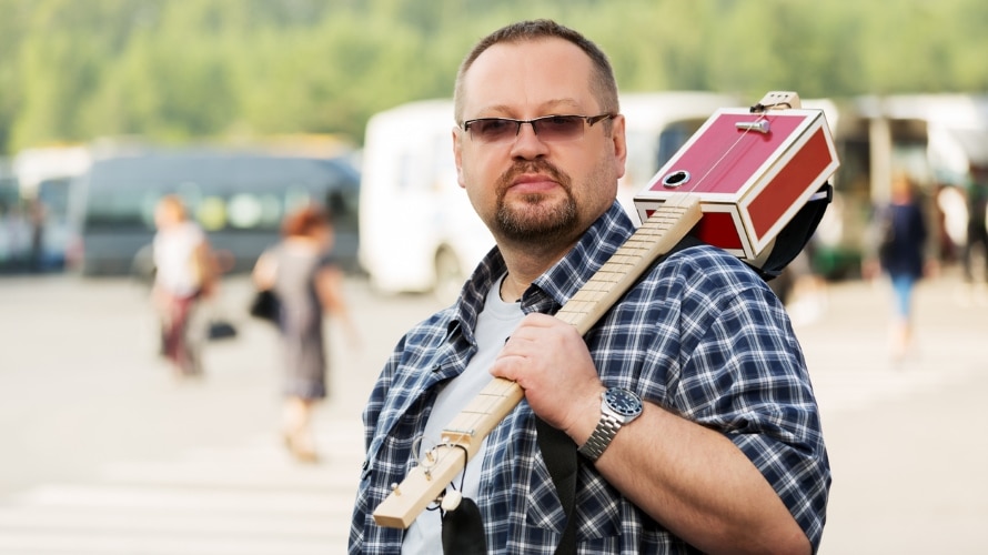 Man with a three string cigar box guitar
