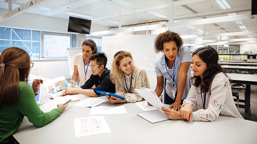 mentor-generation-content-2019 a group of co-workers join together around a table; they are collaborating on a project