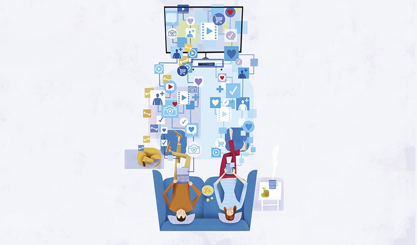 Overhead view of couple sitting on sofa in front of television screen using computers for lots of uses and ignoring each other Two people sitting on a couch, watching tv; between the observers and the tv are various symbols like an instagram like