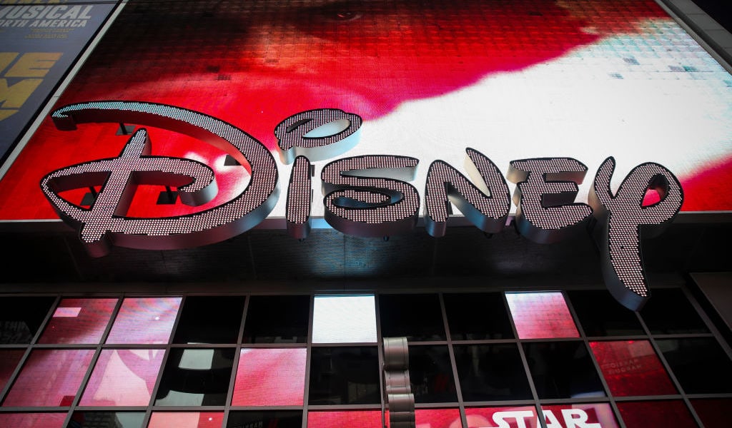 Disney To Buy 21st Century Fox’s Entertainment Business Disney signage below a screen