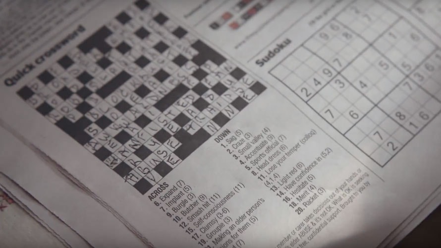 A crossword puzzle from a newspaper with sudoku next to it
