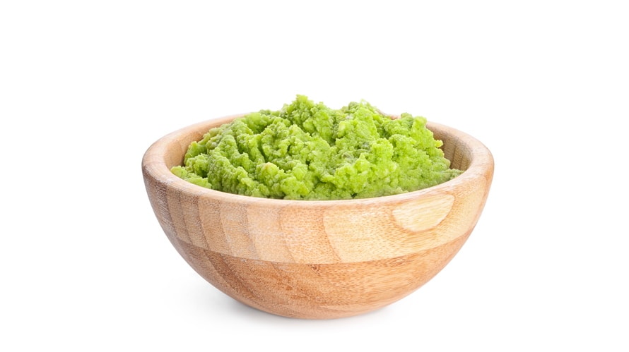 Bowl with delicious guacamole on white background