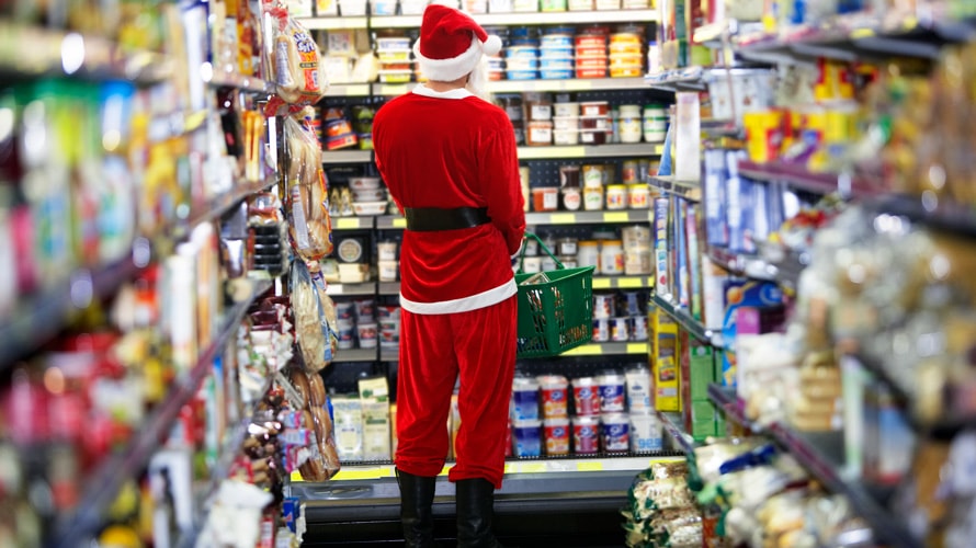 holiday-shopping-prediction-sale-CONTENT-2019 A person in a Santa suit shops.