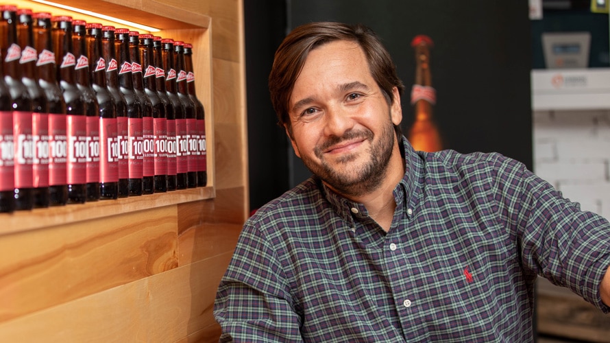 pedro-earp-brandweek-CONTENT-2019 pedro earp next to a line of AB InBev products