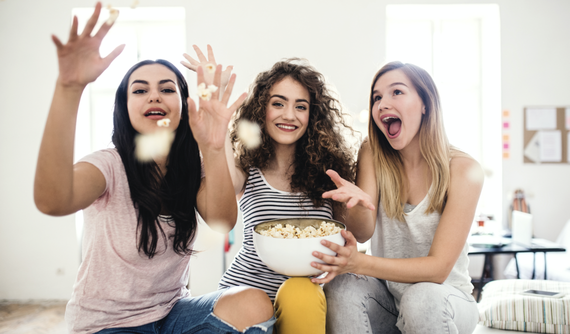 Mondelez_Snack_Study a group of girls eating and throwing popcorn