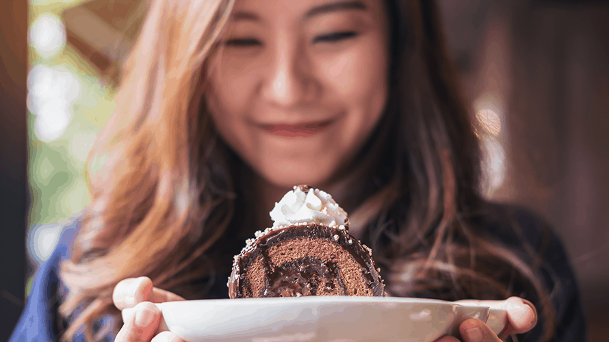 secret-eating-chocolate-content-2019 Woman smiling in front of a chocolate dessert