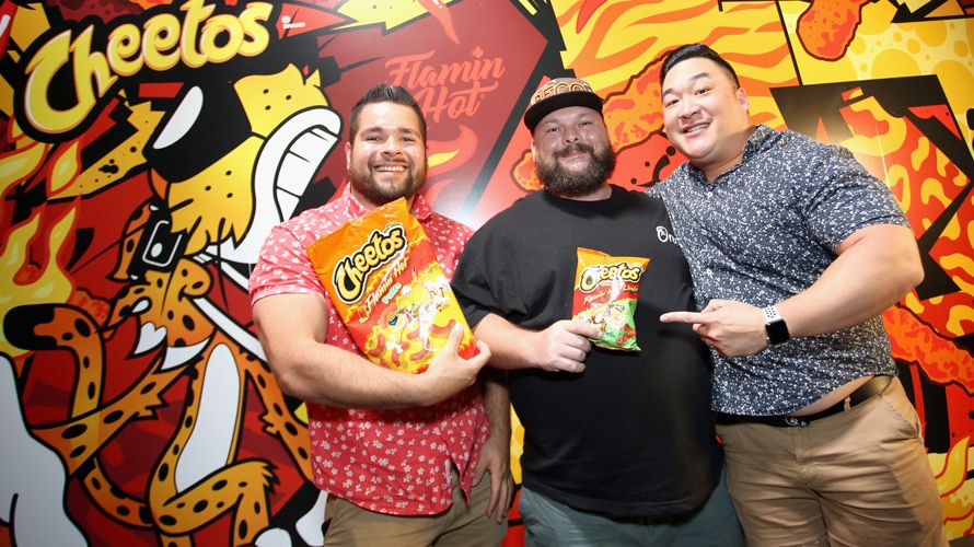 flamin-hot-cheetos-CONTENT-2019 three men standing in front of a cheeto