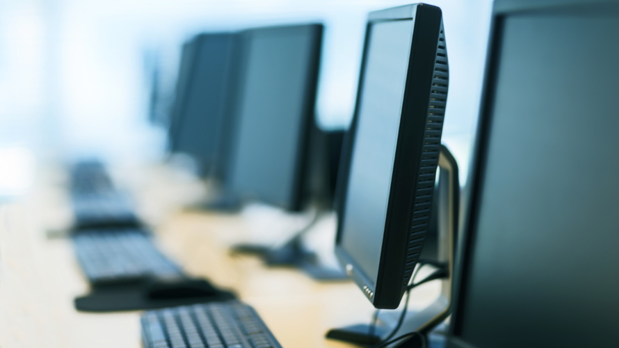 RowOf5MonitorsAndKeyboards