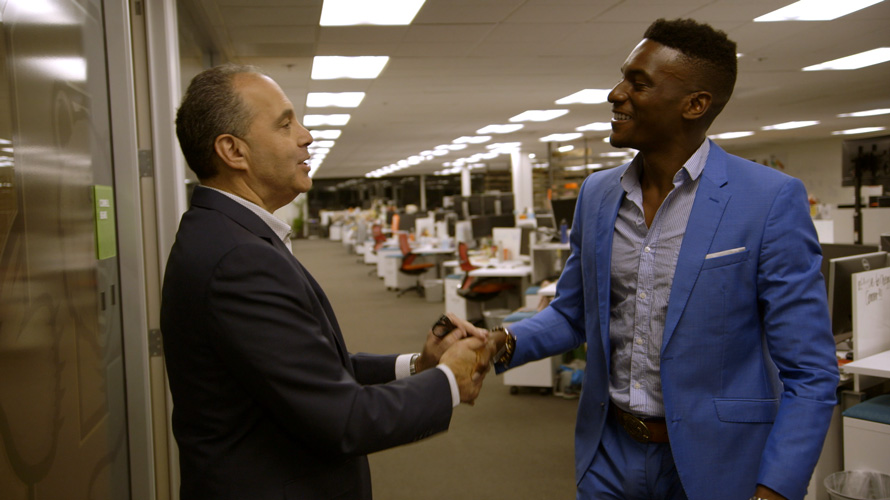 crackle-newfront-going-from-broke-CONTENT-2020 a white man and black man in a blue suit shaking hands in an ofiice