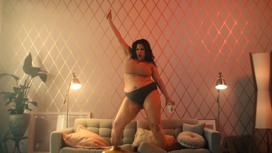 halo-top-dance-eat-CONTENT-2020 Woman dancing on top of a couch with Halo Top in her hand